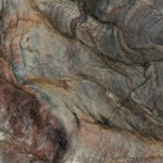 Fusion quartzite slab featuring swirling patterns of blue, green and gold tones, ideal for countertops in Hinsdale. Fusion quartzite slab with swirling patterns of blue, green and gold tones from Hinsdale.