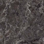 Medium grey quartz with charcoal veining and stone-like texture. Medium grey quartz surface with subtle charcoal veins and natural stone texture.
