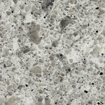 Light grey quartz with salt-like speckles and beige tones. Light grey quartz surface with salt-like speckles in white and beige.