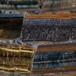 Fiero quartz countertop slab with dark brown, gold and teal bands, ideal for countertops in Oak Brook. Fiero quartz countertop slab featuring dramatic dark brown, gold and teal banding in Oak Brook.